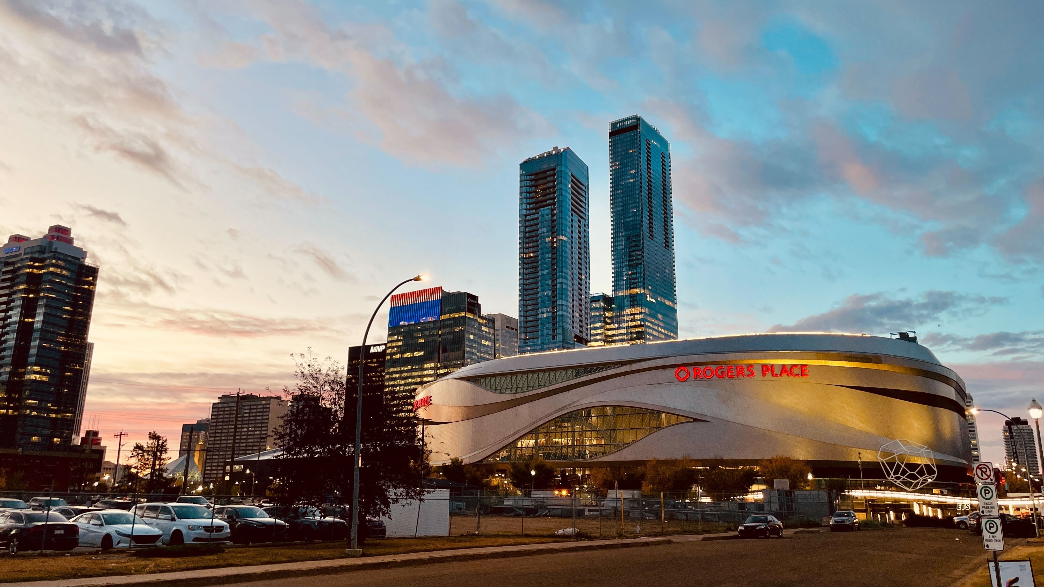 Sunrise colours the sky behind Rogers Place, home of the Edmonton Oilers, on Oct. 8, 2025. (Evan Klippenstein / CTV News Edmonton)