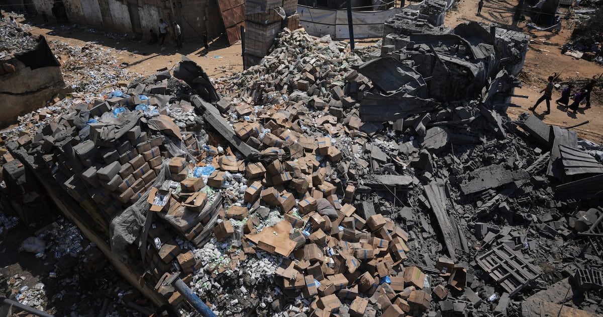 Photo: ctvnews.ca Palestinians walk past a food-aid warehouse damaged in an Israeli airstrike that targeted a nearby house in Deir al-Balah