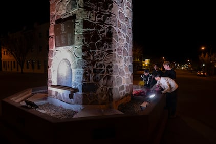 A group of young men pay their respects to the victims of a grass fire that killed four soldiers at CFB Wainwright, at the Memorial Clock Tower on Main Street in Wainwright, Alta., on Sunday, Oct. 18, 2026. THE CANADIAN PRESS/John Ulan