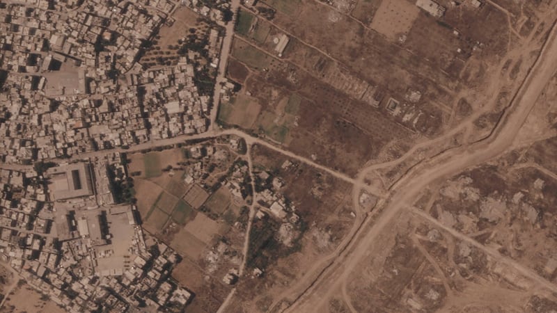 Israel is building a miles-long earthen barrier inside Gaza, entrenching its division