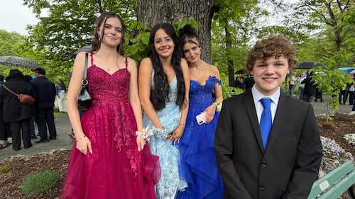 Four high school students pose together for prom.