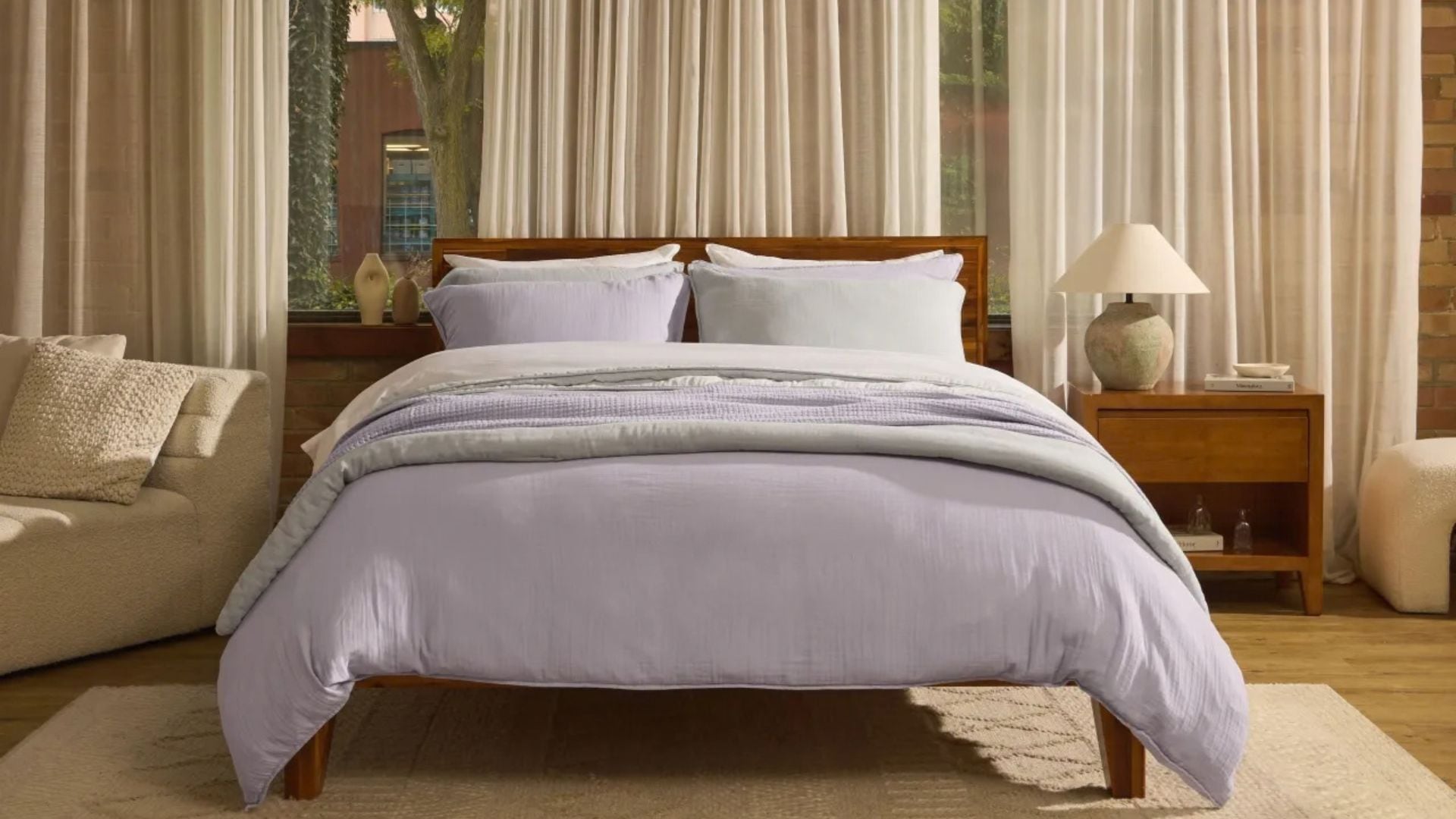 A bed covered in purple Silk & Snow linens.