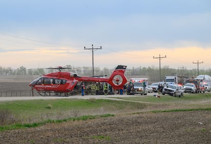 A STARS medical helicopter and an ambulance are shown on Highway 672 near Beaverlodge, Alta., west of Grande Prairie, Alta., after a bus rollover resulted in several passengers being taken to hospital on Wednesday, May 13, 2026. THE CANADIAN PRESS/William Vavrek