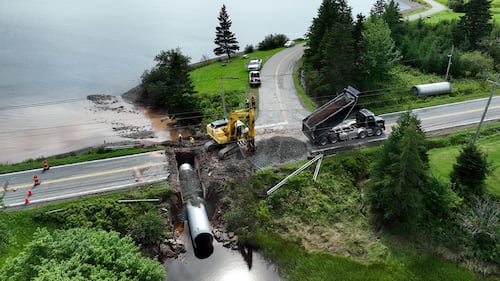 Repair is bring done on a road damaged from flooding in River Bourgeois, N.S. (CTV/Darryl Reeves)
