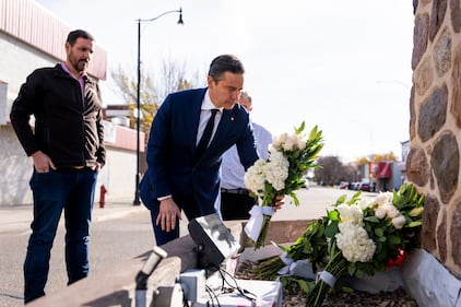 Conservative Leader Pierre Poilievre lays flowers for the victims of a fire that killed four soldiers at CFB Wainwright, at the Memorial Clock Tower on Main Street, in Wainwright, Alta., on Monday, Oct. 19, 2026. THE CANADIAN PRESS/Christopher Katsarov
