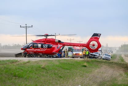 A STARS medical helicopter and an ambulance are shown on Highway 672 near Beaverlodge, Alta., west of Grande Prairie, Alta., after a bus rollover resulted in several passengers being taken to hospital on Wednesday, May 13, 2026. THE CANADIAN PRESS/William Vavrek