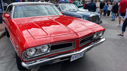 A classic red car is pictured.