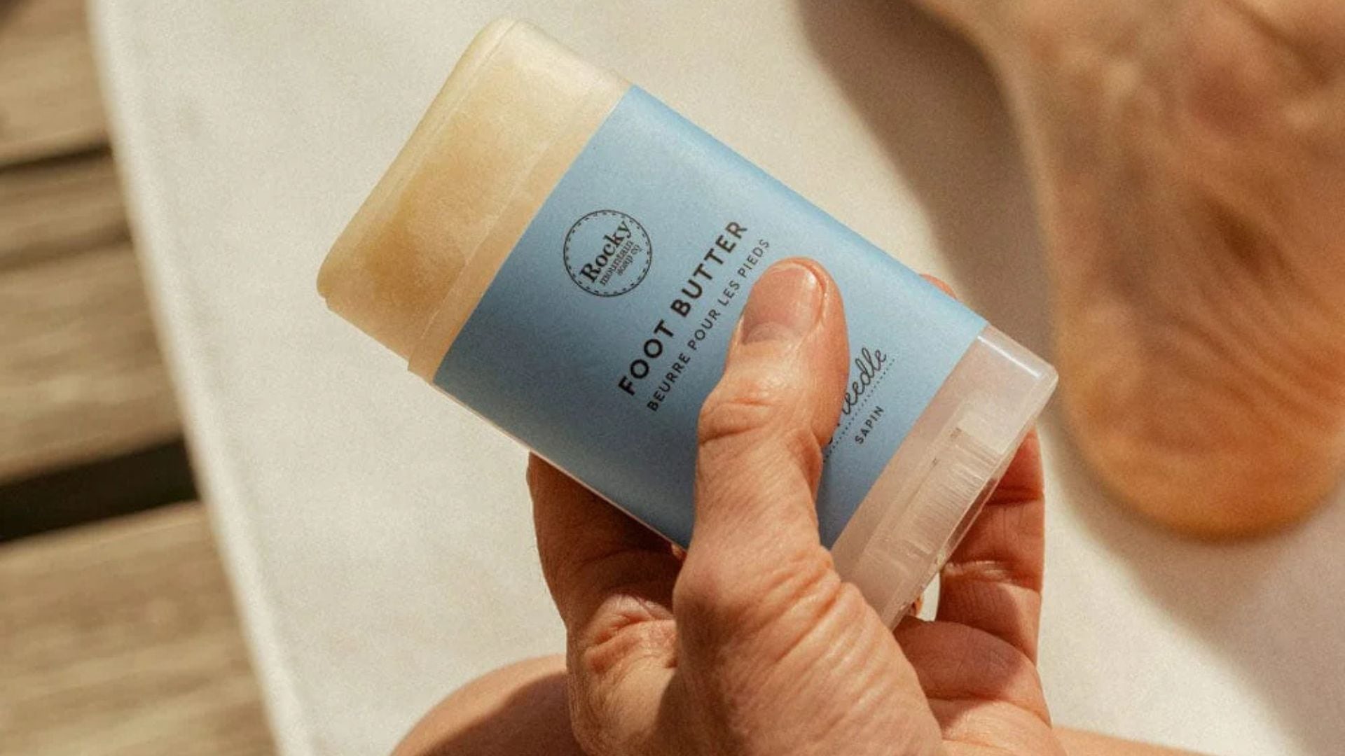 A person holding a Rocky Foot Butter stick.