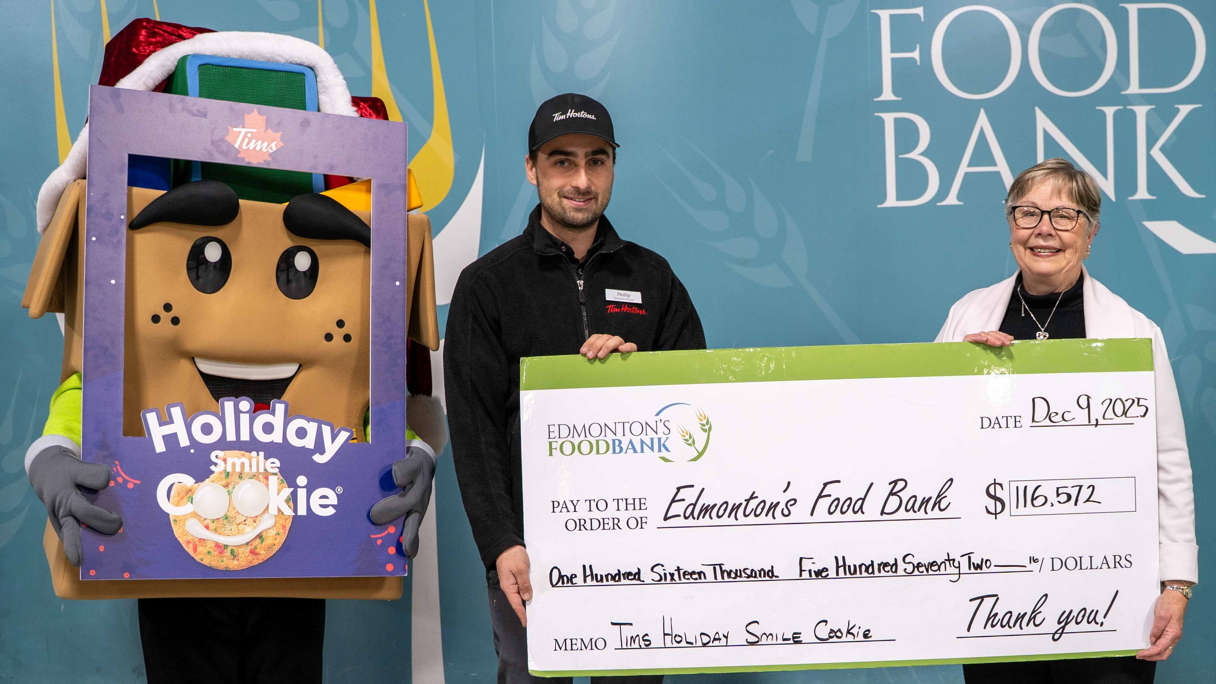 Tim Hortons' Smile Cookie campaign raises $116K for Edmonton's Food Bank. Local Tim Hortons owner Mark Havin seen on the left, Tamisan Bencz-Knight with Edmonton’s Food Bank seen on the right. (Source: Edmonton's Food Bank)