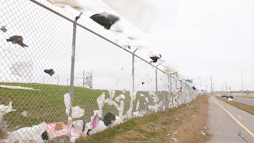 A garbage-covered fence in Calgary after powerful wind gusts on Friday, April 24, 2026.