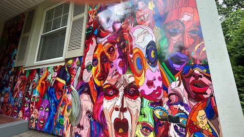 The mural stretches around the entire front of the Brian MacKinnon’s Fredericton home.