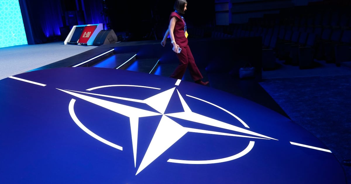 Photo: CTV News A woman walks down steps next to the NATO logo during the NATO Defense Industry Forum at the NATO summit in Ankara, Turkey