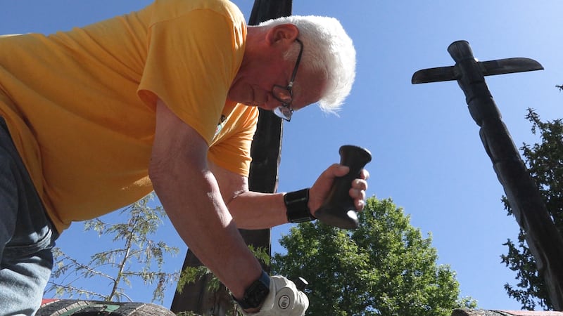 Totem restoration work underway outside of Royal BC Museum