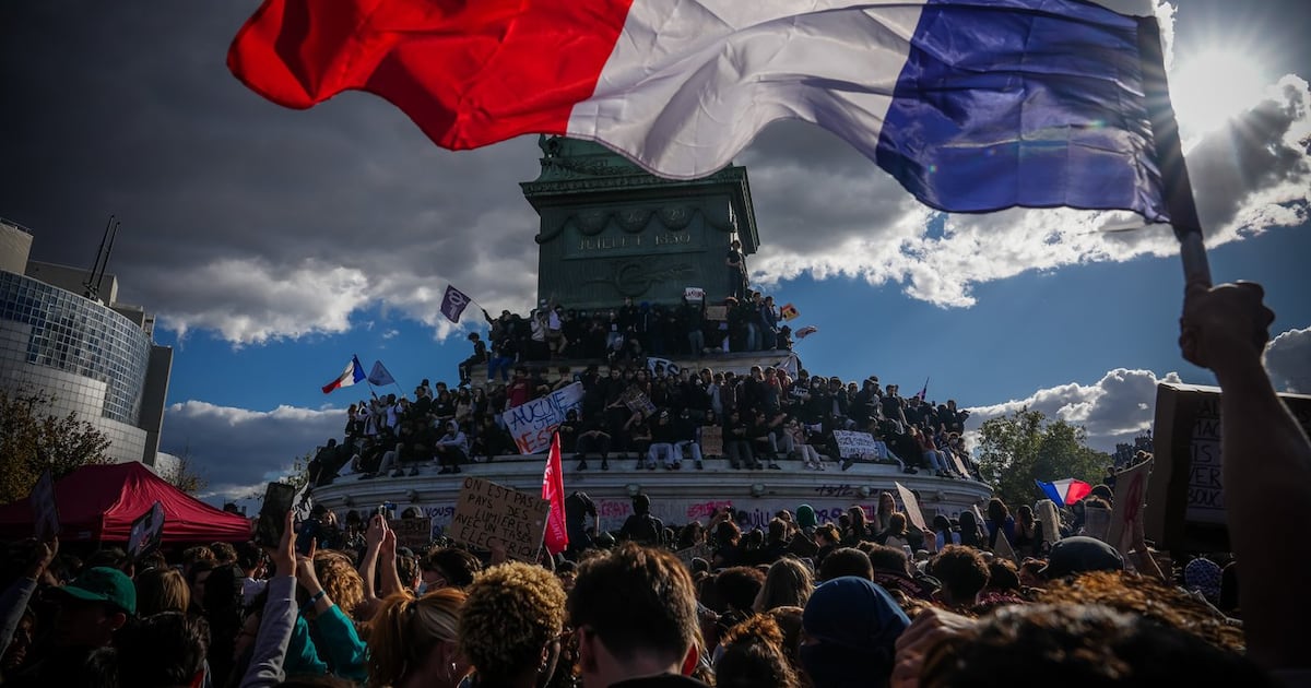 Photo: CTV News A person holds a French national flag during a protest against under-resourced schools in Paris, Thursday, Oct. 8, 2026. (AP