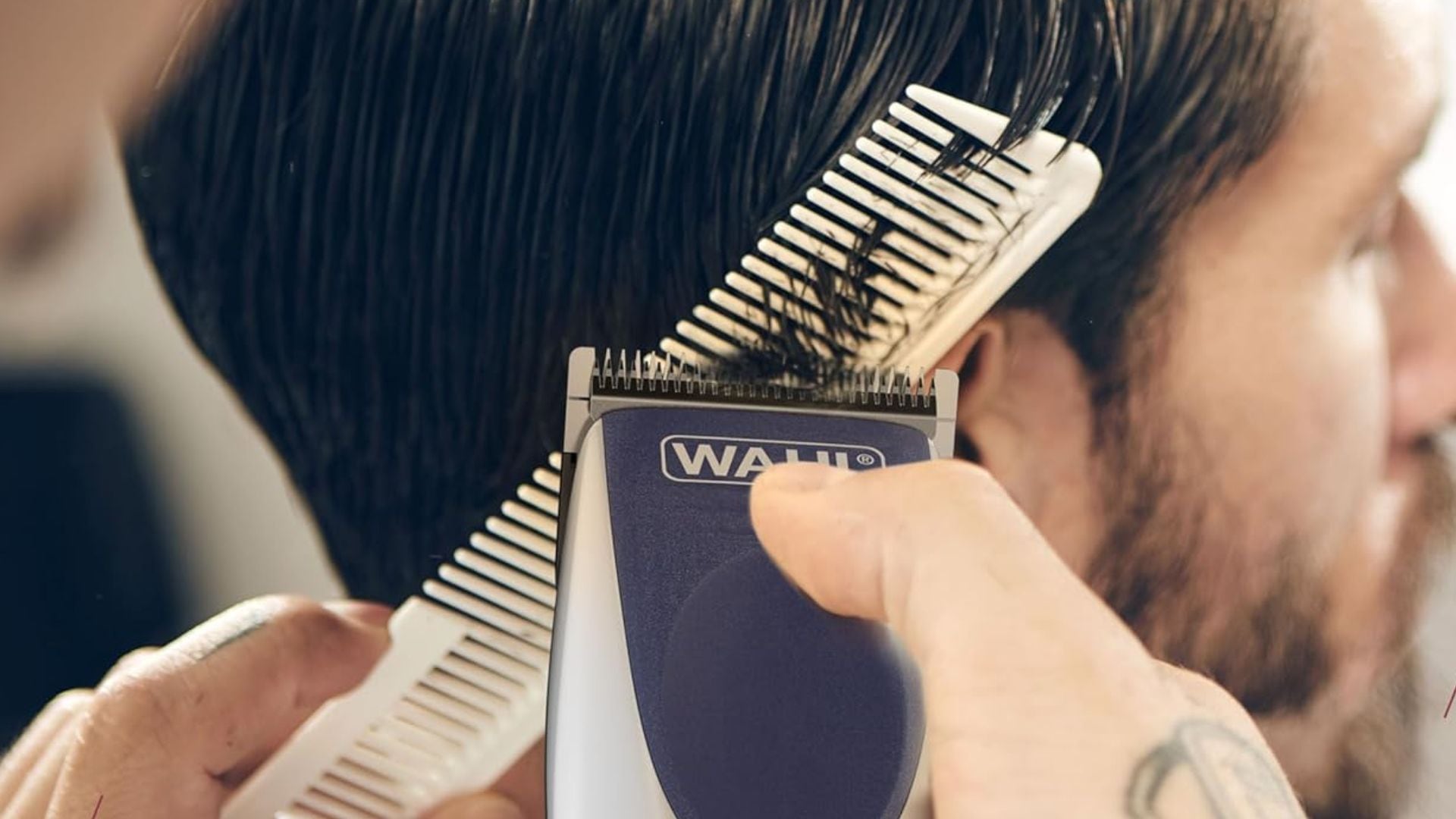 A person trimming hair with Wahl hair clippers.