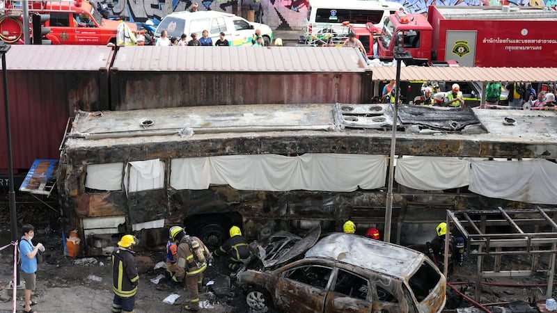 A cargo train hits a public bus at a Bangkok rail crossing, killing at least 8