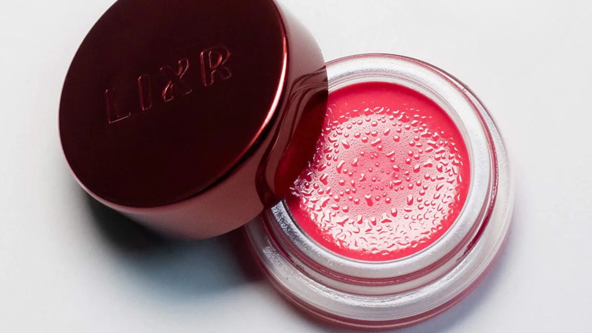 A pot of LIXR lip mask in a tinted berry shade.