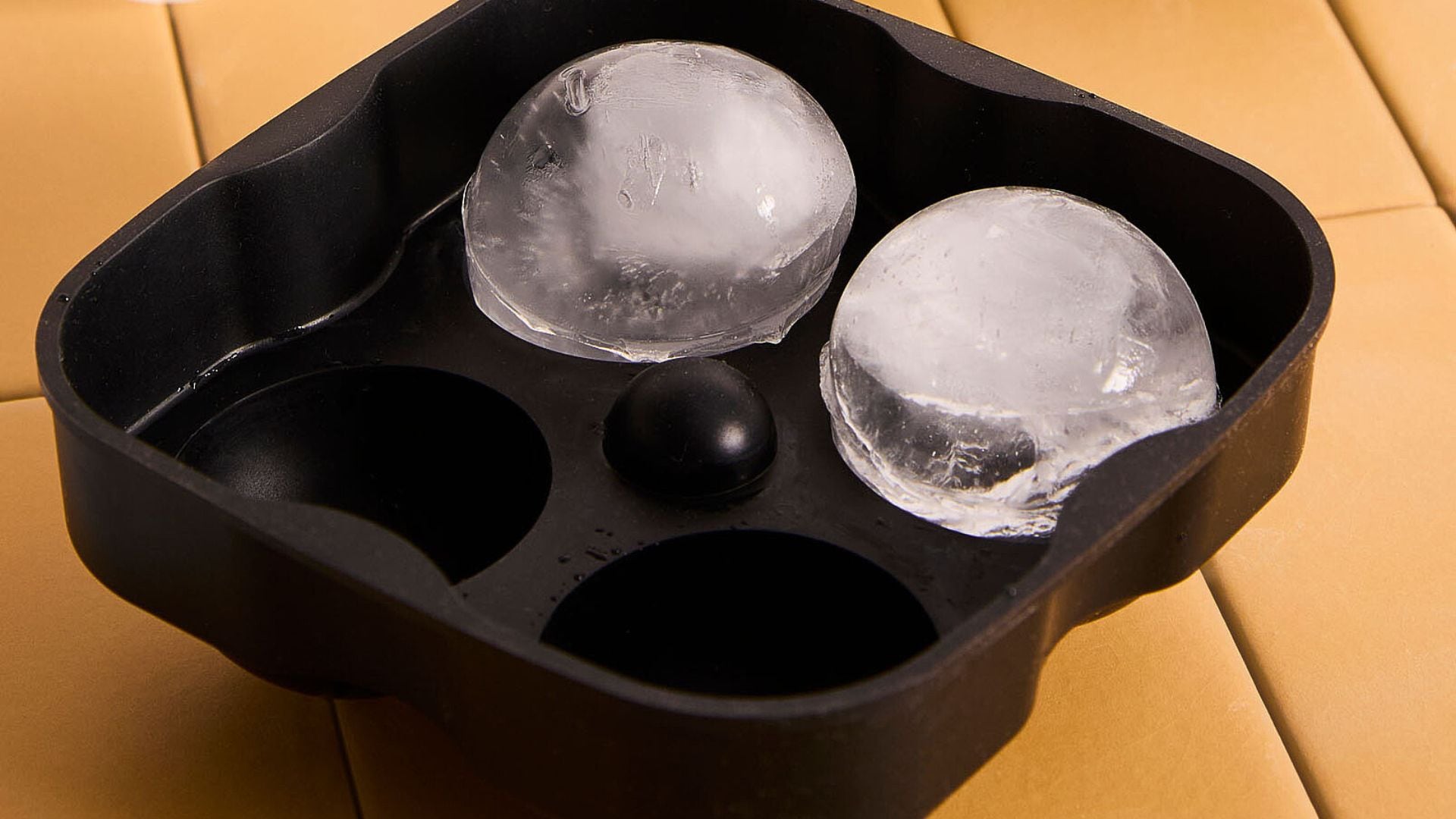 Two ice globes in a Simons Maison ice cube tray.