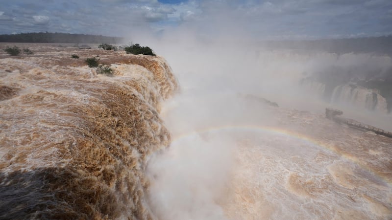 El Niño rains flood South America, sending residents fleeing and cattle swimming