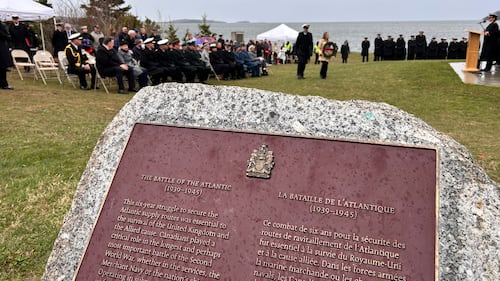 A plaque on a rock is pictured.