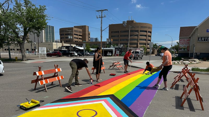 ‘We want to celebrate love, inclusion and acceptance”: Regina volunteers paint pride crosswalk after first was vandalized