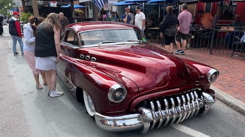 A classic red car is pictured.