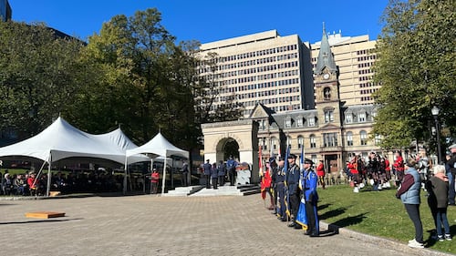 Officers stand at a memorial service.