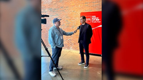 A reporter speaks with a man.