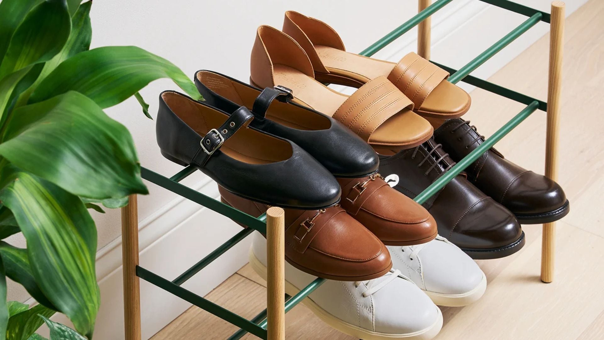 A Yamakazi Home shoe organizer with six pairs of shoes on it.