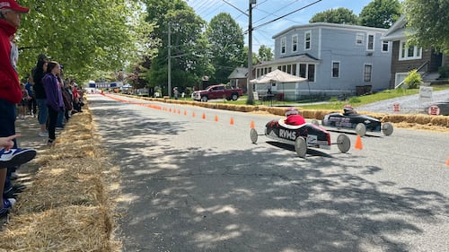 Soap box derby drivers are pictured racing.