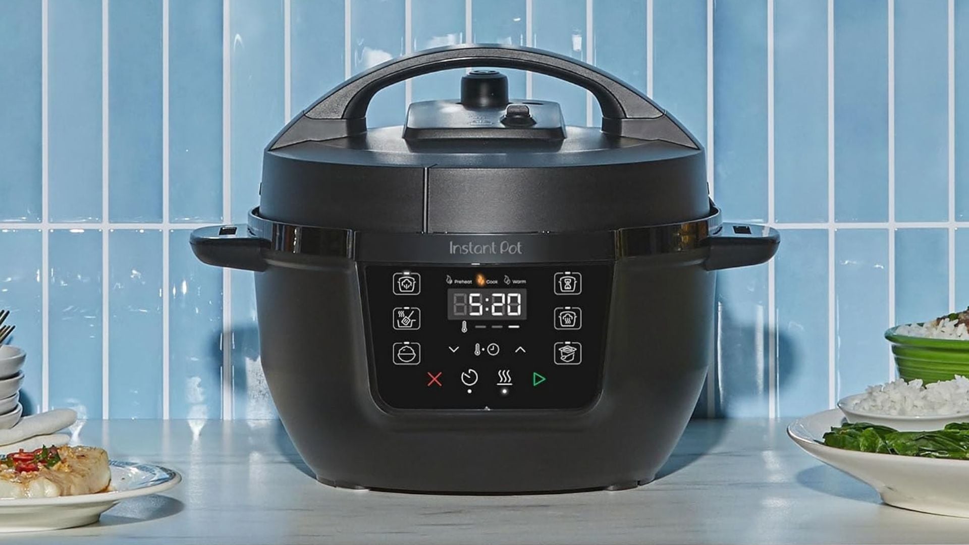 An Instant Pot on a counter in front of a blue backsplash.