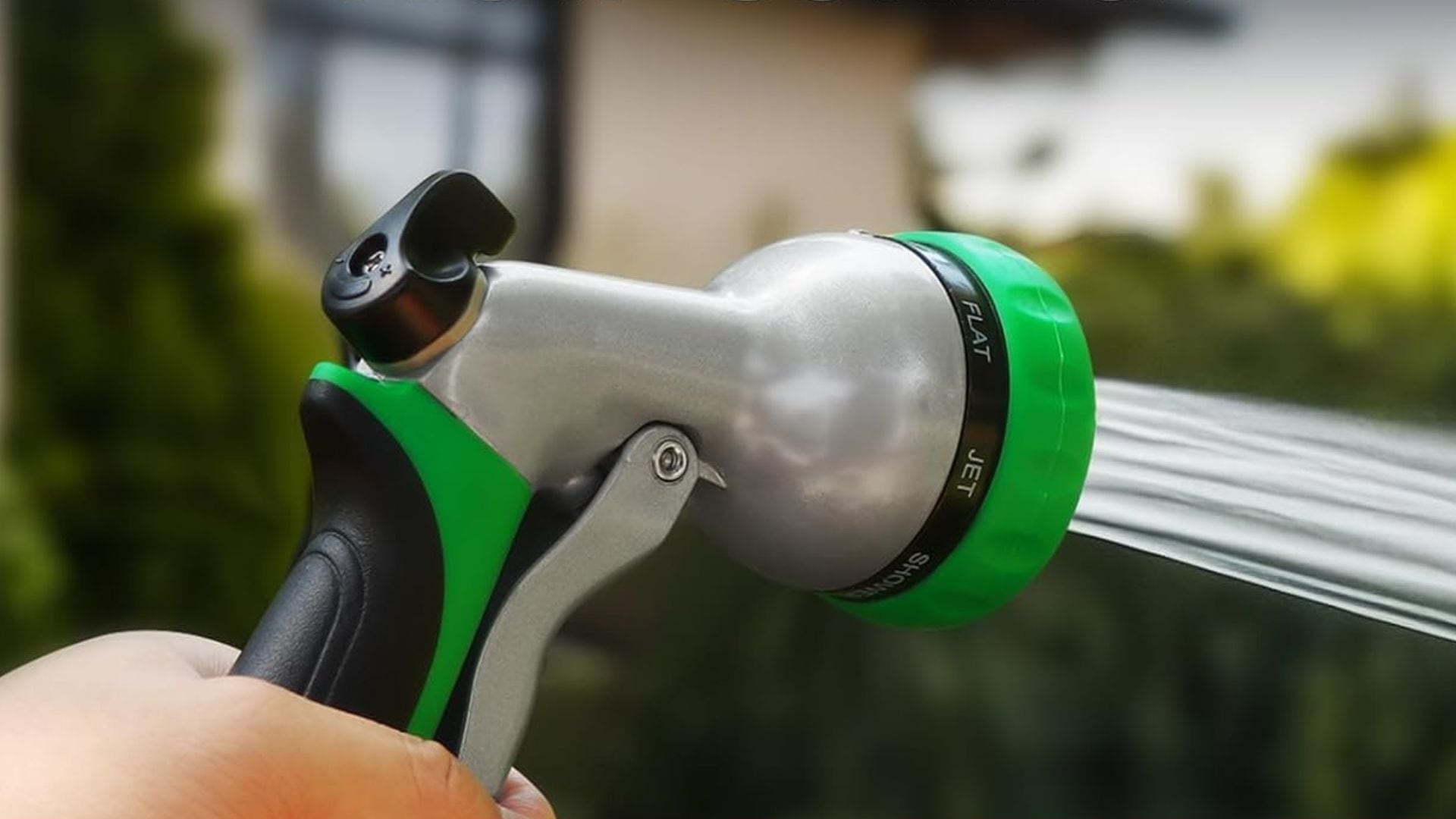 A person watering their lawn with the RESTMO Garden Hose Nozzle