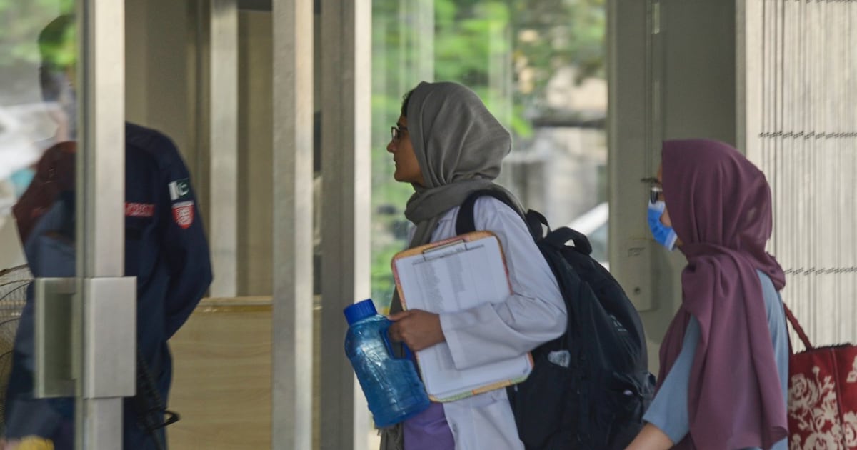 Hospital staff enter the Mother and Child Health ward at the Pakistan Institute of Medical Sciences, in Islamabad, Pakistan, Thursday, Aug. 27, 2026. (AP Photo/M.A. Sheik)