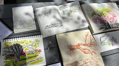 A table full of paintings is pictured.