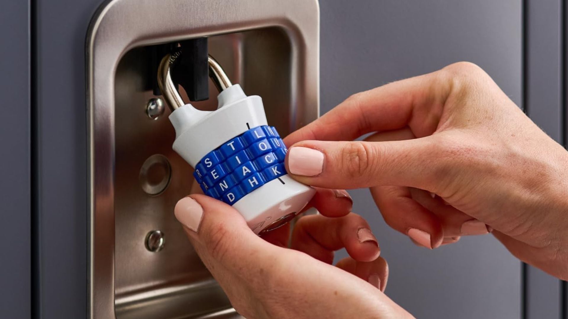 A person putting in the passcode on a Master Lock.