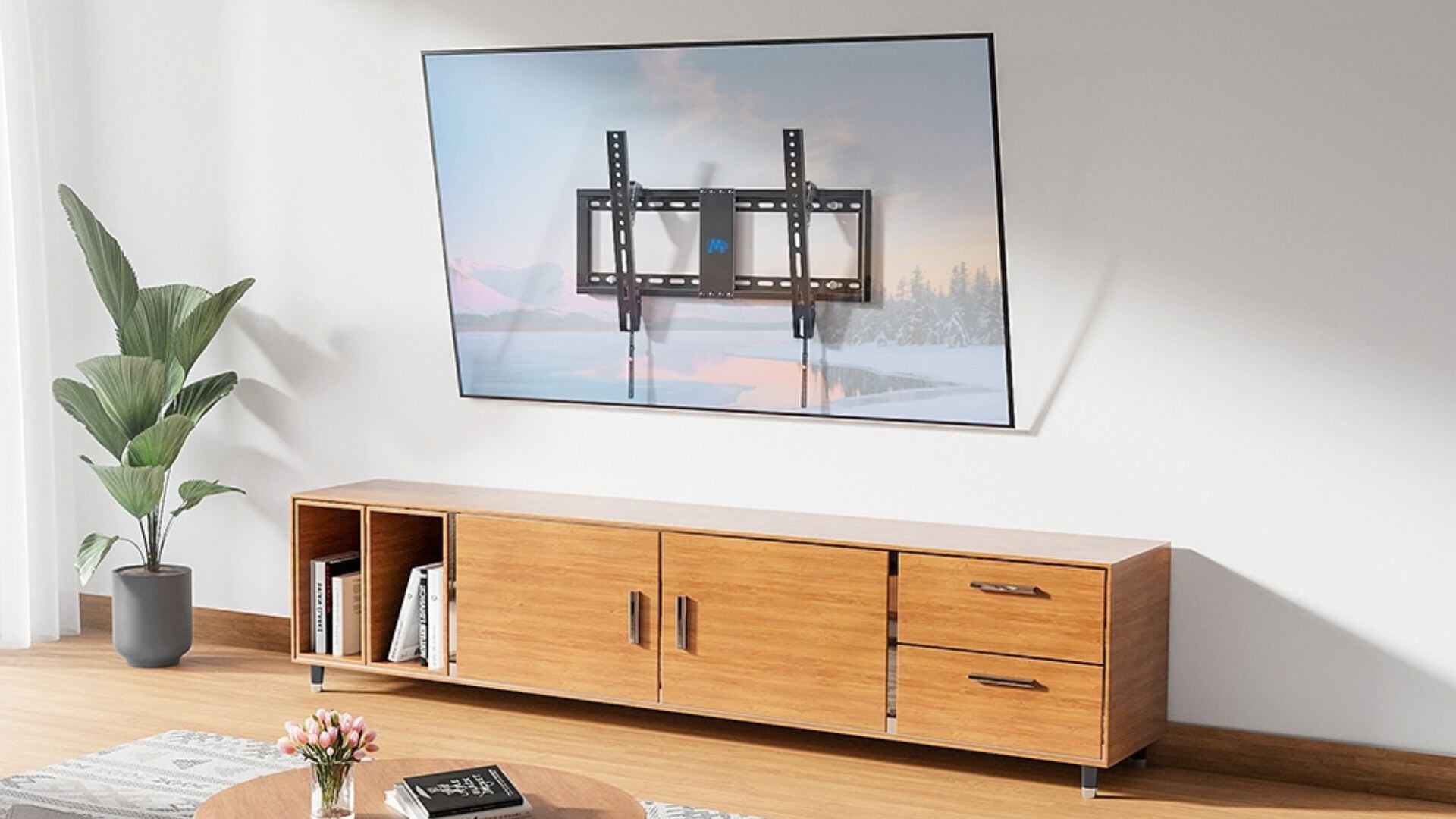 A TV mounted in a living room above an entertainment unit.