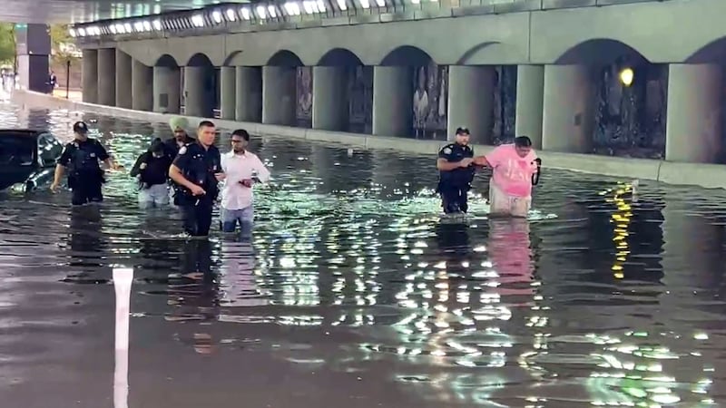 WATCH: Police help stranded drivers in flooded downtown Toronto underpass