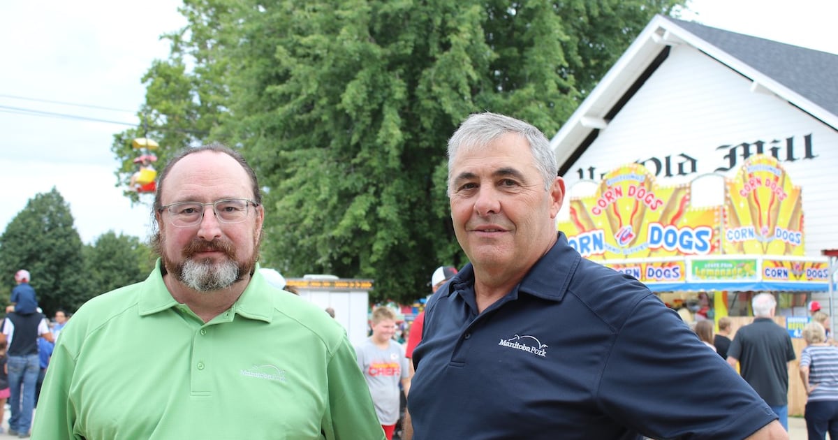 Cam Dahl, left, general manager of Manitoba Pork and Rick Prejet, chair of Manitoba Pork, pose for a photo at the Iowa State Fair in Des Moines, Iowa, after they met with their American counterparts, on Friday, Aug. 14, 2026. THE CANADIAN PRESS/Kelly Geraldine Malone
