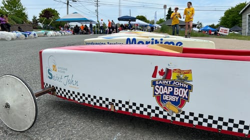 A white soap box derby car is pictured.