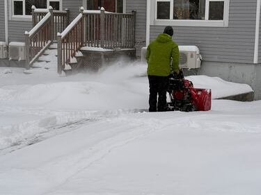 A person is pictured snow blowing their driveway in Halifax on Jan. 26, 2026. (CTV Atlantic / Brianne Foley)