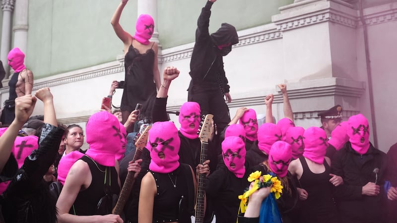 Protesters in pink balaclavas swarm Russia’s pavilion at Venice Biennale and release coloured smoke