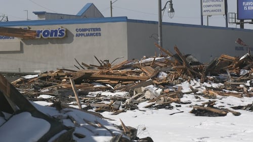 Piles of debris from a Feb. 19 fire at the Jasper Place Hotel sit on the lot on April 1, 2026. (Galen McDougall/CTV News Edmonton)