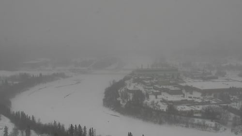 Snow obscures an aerial view of Edmonton's Walterdale Bridge over the North Saskatchewan River during a storm on Feb. 17, 2026. (CTV News Edmonton)