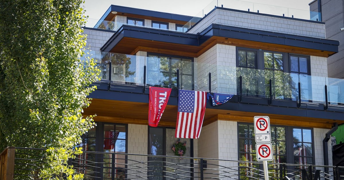 An American flag and Trump flags adorn a house in Calgary, Monday, Aug. 31, 2026. (THE CANADIAN PRESS/Jeff McIntosh)
