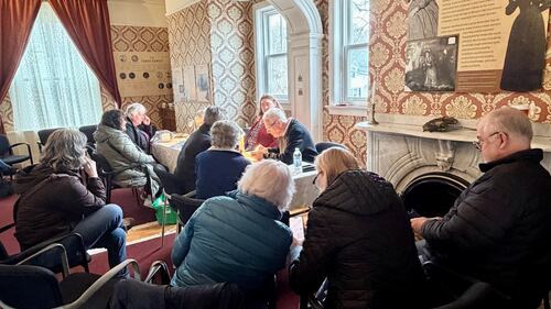 A group of people sit in a room.
