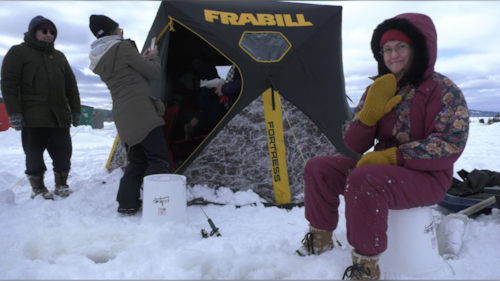 An angler is pictured smiling and waving for a picture at the Dominion Park Family Day ice fishing event in Saint John, N.B. (Avery MacRae / CTV Atlantic)
