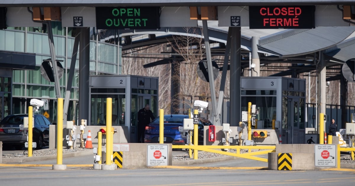 A Canada Border Services Agency officer speaks to a motorist entering Canada at a very quiet Douglas-Peace Arch border crossing, amid concerns about the spread of the coronavirus in Surrey, B.C., on Wednesday, March 18, 2020. THE CANADIAN PRESS/Darryl Dyck