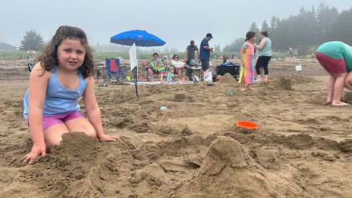 A young sand sculptor poses with her crab waterpark sand creation. (CTV/Avery MacRae)