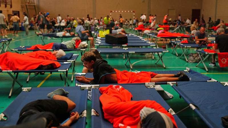 More than 200,000 people flee raging wildfires in France and Spain, some escaping by boat