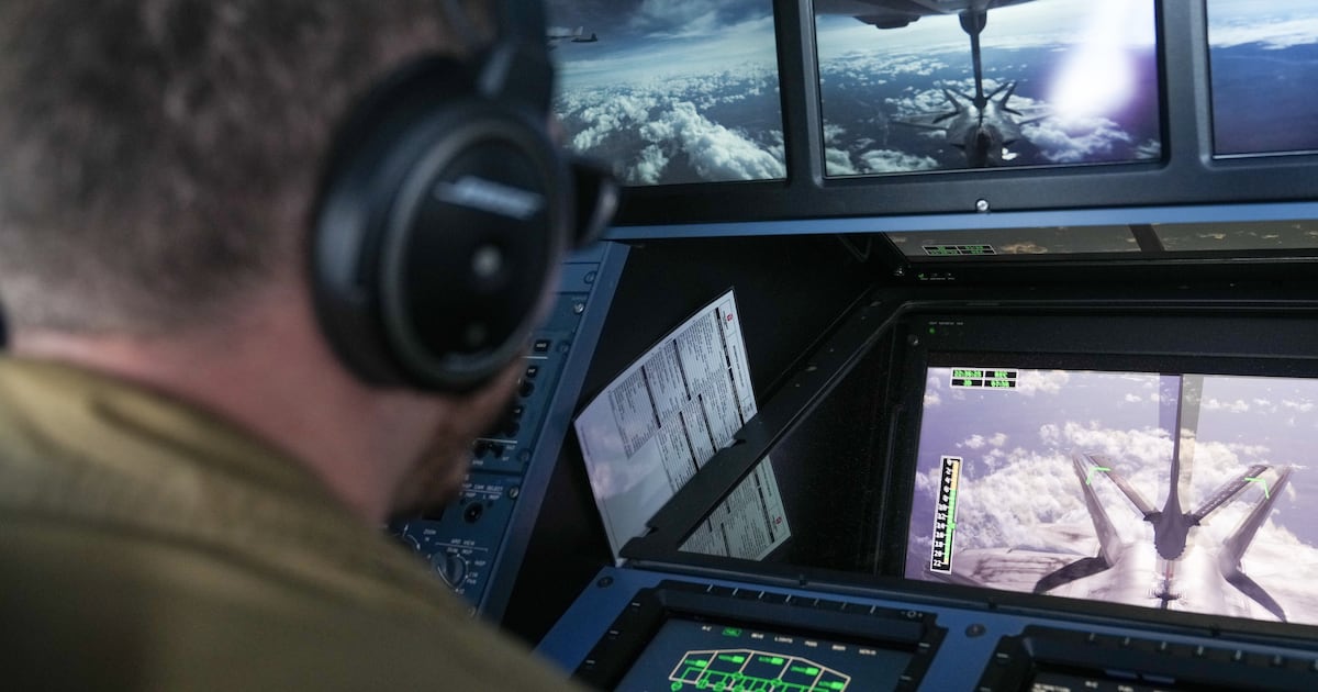 A French Air and Space Force operator monitors the aerial refuelling of a U.S. Air Force F-22 Raptor fighter jet from a French Military aircraft. (AP Photo/Nicolas Garriga)
